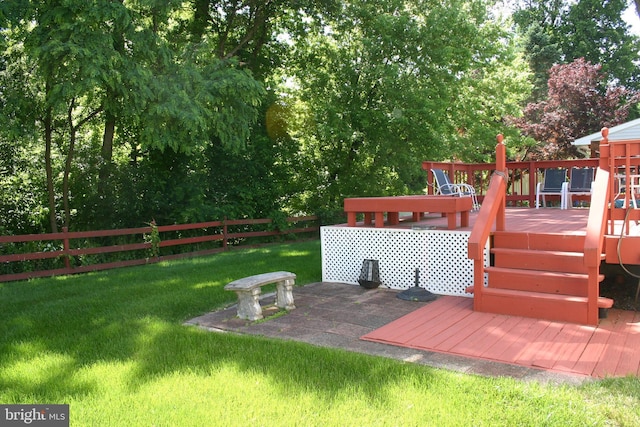 wooden terrace featuring a yard