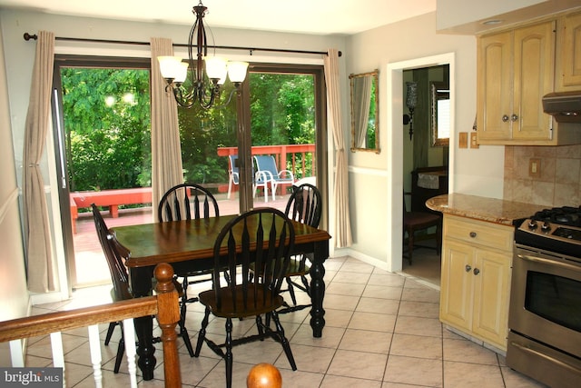 dining space with light tile patterned floors and an inviting chandelier