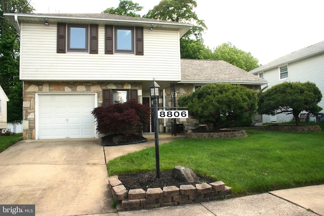 view of front of property with a front yard and a garage