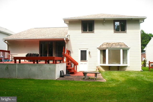 rear view of house featuring a yard and a wooden deck