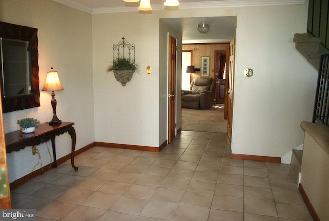 corridor with ornamental molding and light carpet