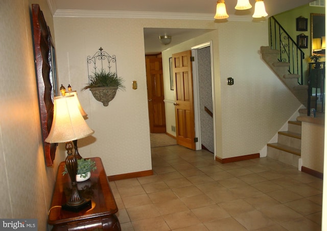 corridor featuring tile patterned floors, an inviting chandelier, and ornamental molding