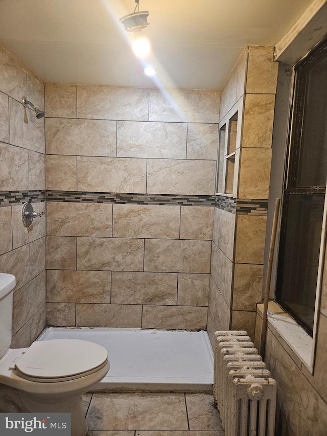 1740 N 3rd St, Philadelphia, PA 19122 - full bathroom featuring toilet, radiator heating unit, tiled shower, and tile patterned floors