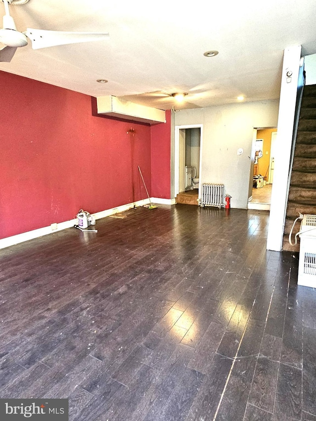 interior space featuring dark hardwood / wood-style flooring and radiator heating unit