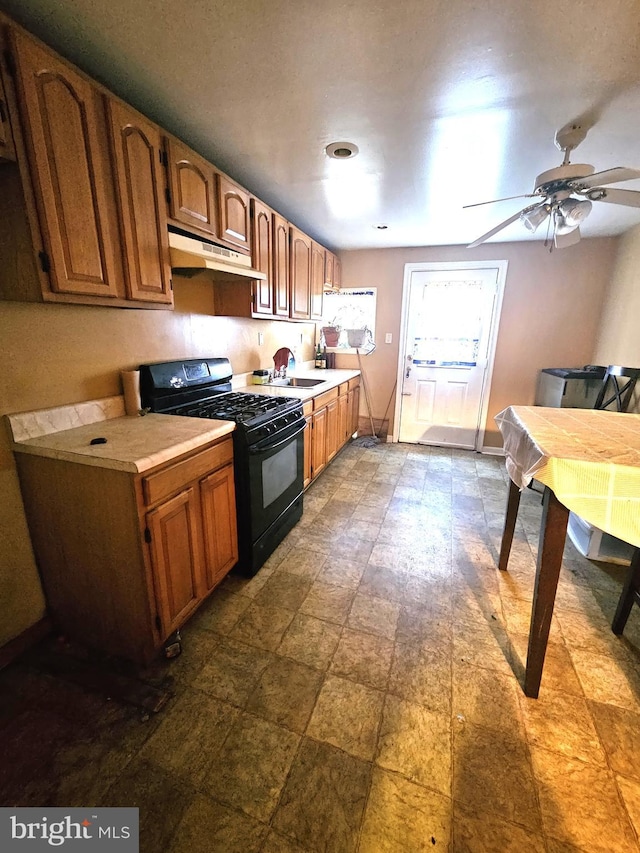 kitchen with ceiling fan, sink, and black gas range oven