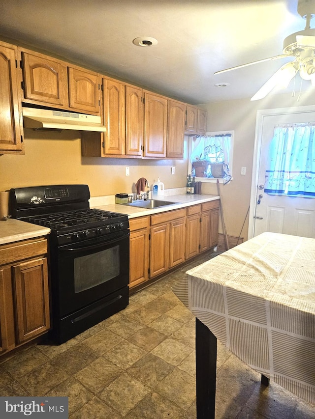 kitchen with ceiling fan, black gas stove, and sink