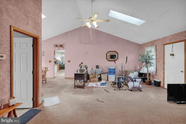 living room featuring ceiling fan, light carpet, and lofted ceiling with skylight