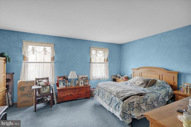 carpeted bedroom featuring multiple windows