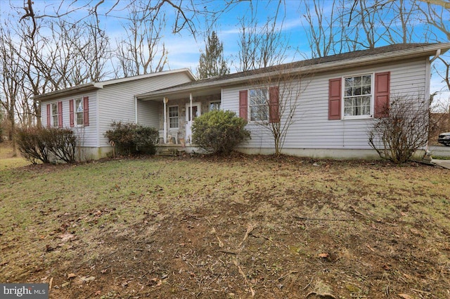 ranch-style house with a porch and a front lawn