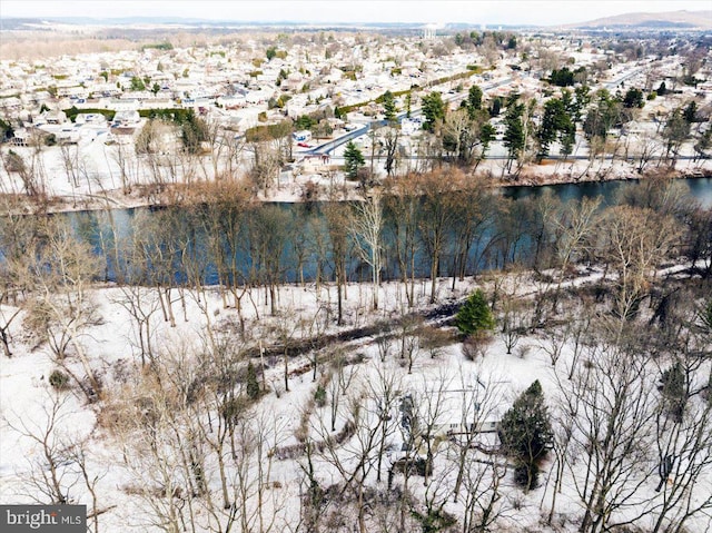 snowy aerial view featuring a water view