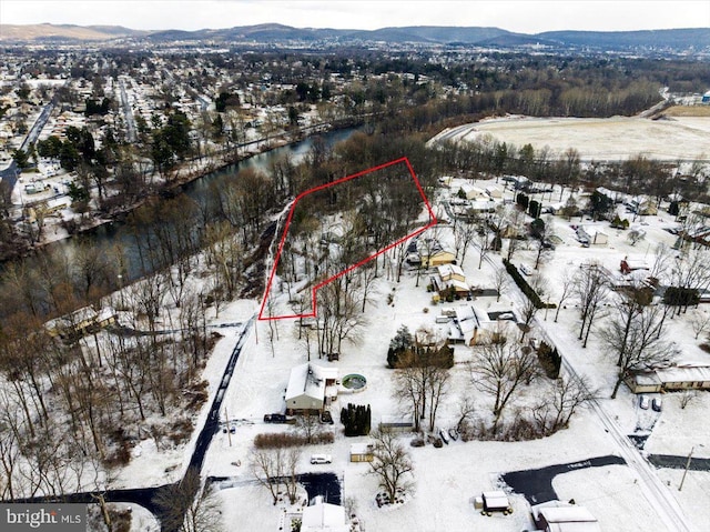 snowy aerial view featuring a mountain view