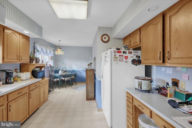 kitchen featuring white fridge and decorative light fixtures