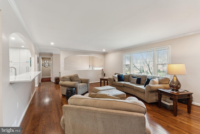 living room with dark hardwood / wood-style flooring and crown molding