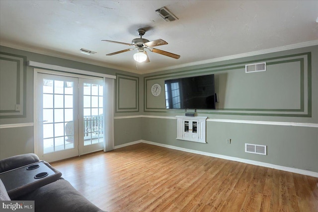 unfurnished living room featuring light hardwood / wood-style floors, ceiling fan, and ornamental molding