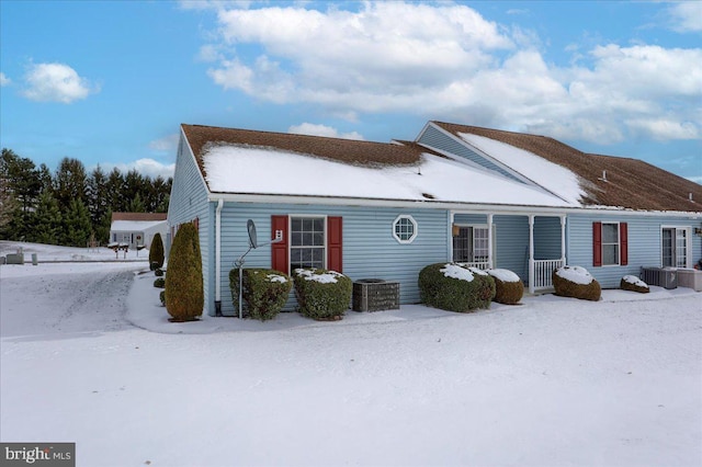 snow covered property featuring covered porch