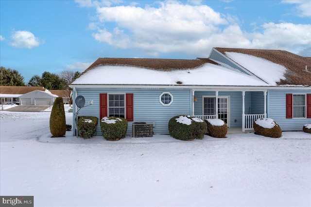 view of snow covered rear of property