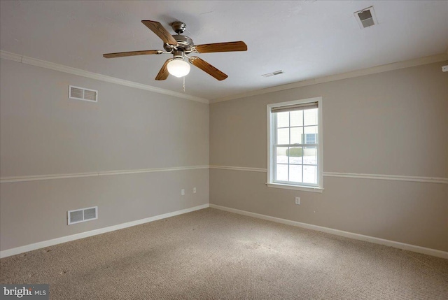 carpeted spare room featuring crown molding and ceiling fan