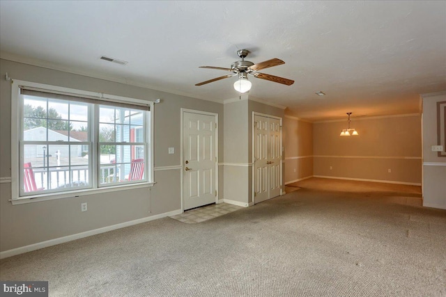 interior space featuring ceiling fan with notable chandelier and ornamental molding