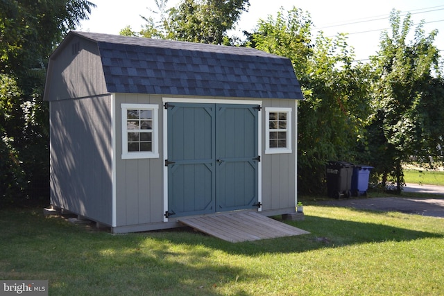 view of outbuilding featuring a yard