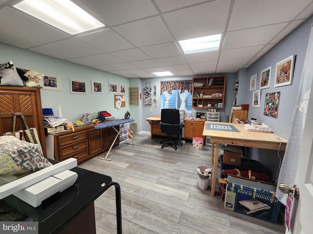 office area with a paneled ceiling