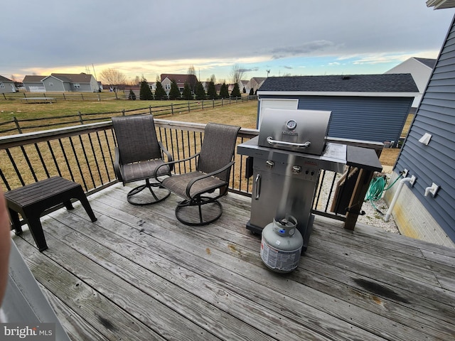 wooden deck featuring a lawn