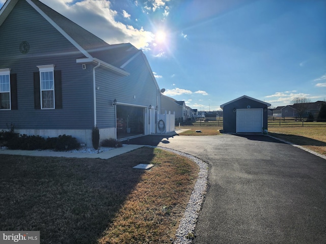 view of property exterior featuring a garage and an outdoor structure