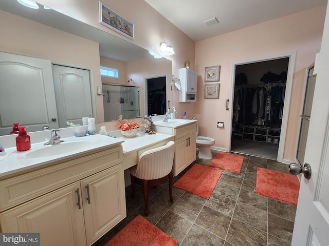 bathroom featuring vanity, toilet, and an enclosed shower