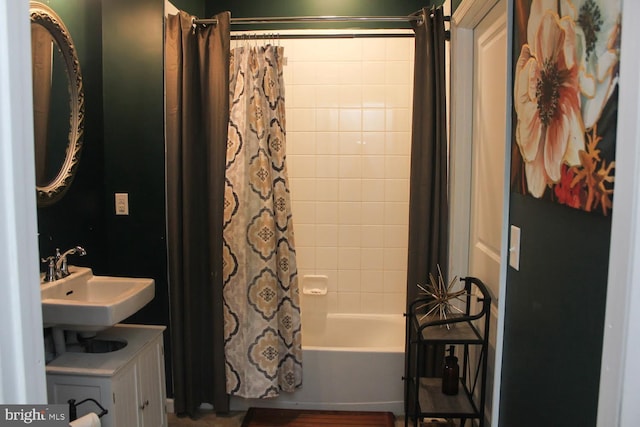 bathroom with sink and shower / tub combo with curtain