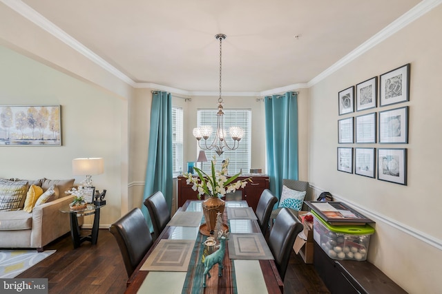 dining room with dark hardwood / wood-style floors, an inviting chandelier, and crown molding