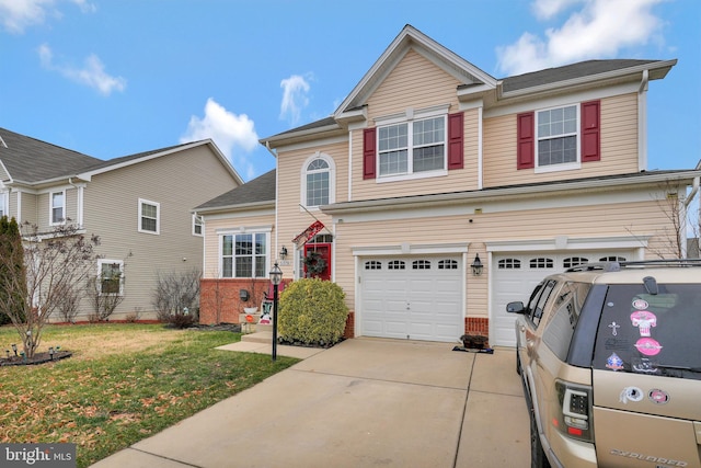 view of front of home featuring a garage and a front lawn