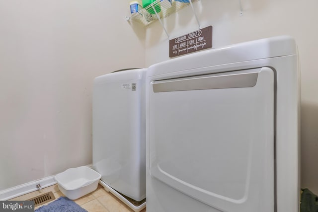 laundry room with tile patterned floors