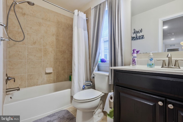 full bathroom with shower / tub combo with curtain, vanity, and toilet