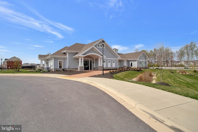 craftsman-style home with a front yard