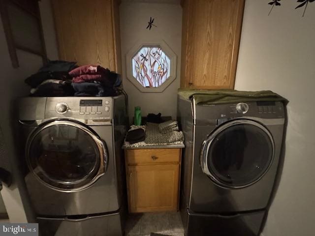 laundry area featuring independent washer and dryer and cabinets