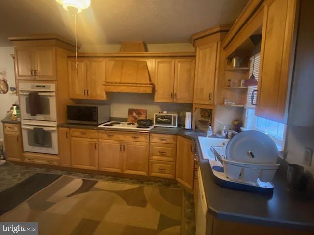 kitchen featuring white appliances and premium range hood