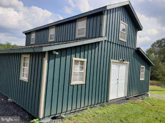 view of side of home with a yard