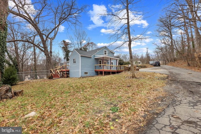 view of side of property with a lawn and a porch