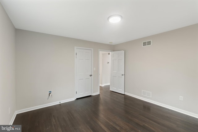 spare room featuring dark hardwood / wood-style floors