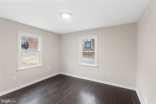 unfurnished room featuring dark hardwood / wood-style flooring