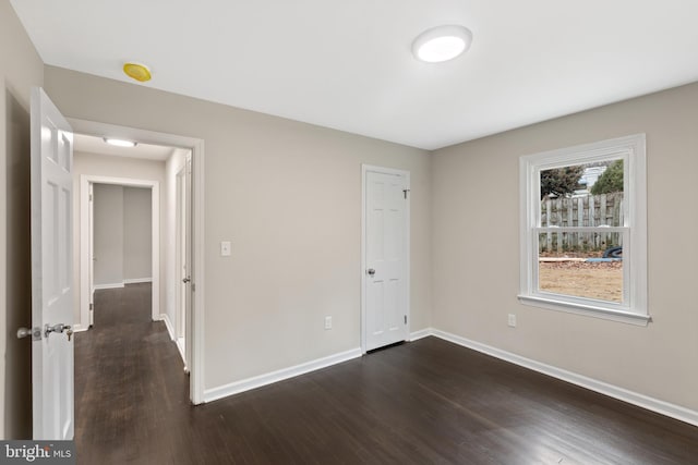 unfurnished bedroom featuring dark hardwood / wood-style flooring