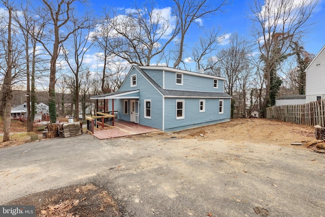 rear view of property featuring a porch