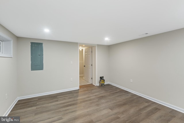 empty room featuring wood-type flooring and electric panel