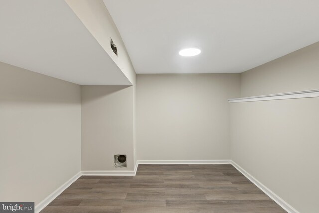 laundry room featuring hookup for an electric dryer and dark hardwood / wood-style flooring