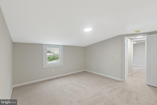 interior space with lofted ceiling and light carpet