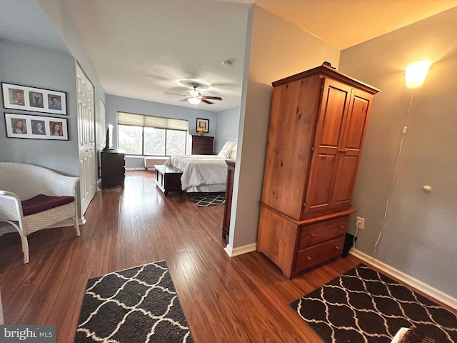 bedroom featuring ceiling fan and dark wood-type flooring