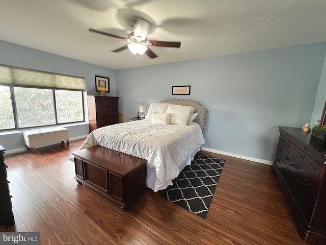 bedroom featuring ceiling fan and dark wood-type flooring