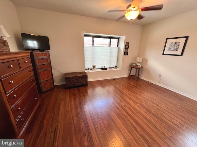 unfurnished bedroom with dark hardwood / wood-style floors and ceiling fan