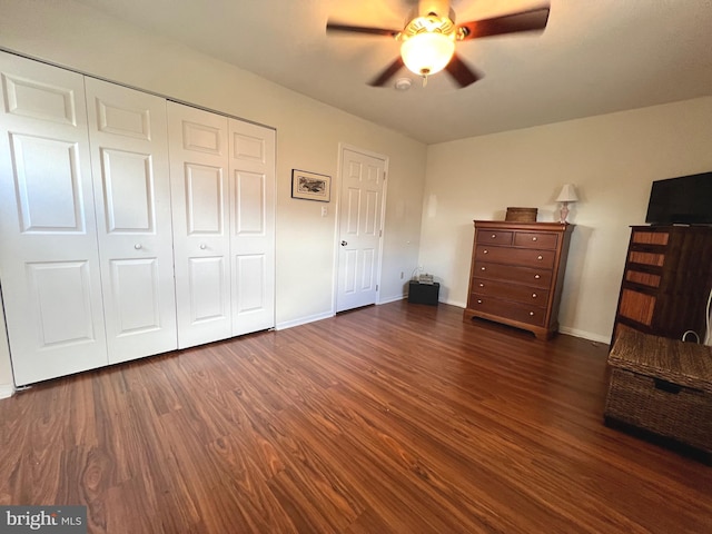 unfurnished bedroom featuring ceiling fan and dark hardwood / wood-style flooring