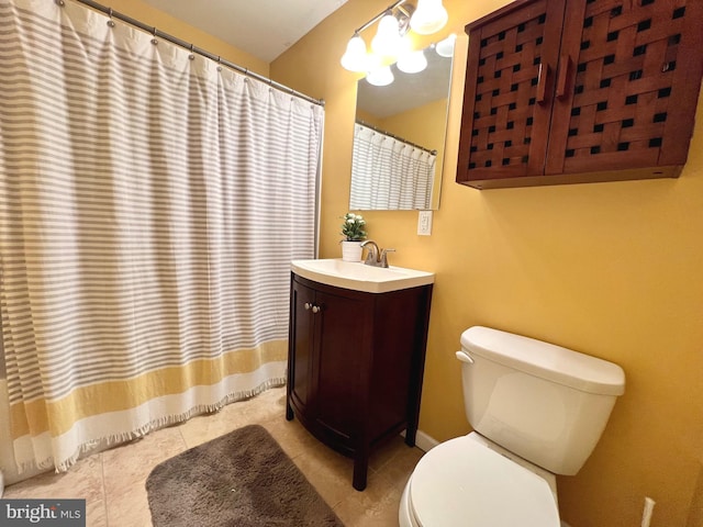 bathroom featuring tile patterned floors, vanity, and toilet