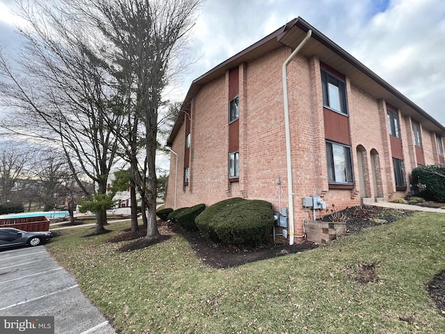 view of side of home featuring a yard